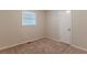 Well-lit bedroom with neutral walls, carpet flooring, and a closet at 404 Utoy Sw Cir, Atlanta, GA 30331