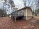 Tan house with deck and stairs leading to the backyard at 6871 Lakeshore Dr, Douglasville, GA 30135
