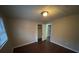 Bedroom with dark hardwood floors and a closet at 6871 Lakeshore Dr, Douglasville, GA 30135