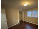 Simple bedroom with dark hardwood floors and a closet at 6871 Lakeshore Dr, Douglasville, GA 30135