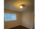 Bedroom with dark hardwood floors and a window at 6871 Lakeshore Dr, Douglasville, GA 30135
