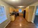 Kitchen with light wood cabinets, black appliances, and hardwood floors at 6871 Lakeshore Dr, Douglasville, GA 30135