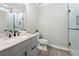 Basement bathroom with gray vanity, marble countertop, and glass shower at 1102 Sweet Mia Ln, Powder Springs, GA 30127