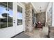 Front porch with stone flooring and wicker chairs at 1102 Sweet Mia Ln, Powder Springs, GA 30127