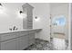 Grey bathroom with patterned floor tile, vanity, and access to another room at 153 Palisade Dr, Rydal, GA 30171