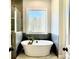 Relaxing bathroom with a freestanding tub, tile shower, and modern vanity at 153 Palisade Dr, Rydal, GA 30171