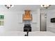 Modern kitchen with white cabinets, marble countertops, and a wooden hood at 153 Palisade Dr, Rydal, GA 30171