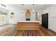 Modern kitchen with white cabinets, large island, and wood countertops at 153 Palisade Dr, Rydal, GA 30171
