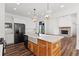 Modern kitchen with white cabinets, large island with farmhouse sink, and hardwood floors at 153 Palisade Dr, Rydal, GA 30171