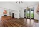 Open living room with hardwood floors, fireplace, and access to backyard at 153 Palisade Dr, Rydal, GA 30171