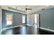 Main bedroom with dark hardwood floors, ceiling fan and ensuite bathroom at 153 Palisade Dr, Rydal, GA 30171