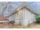 Exterior shot of the back of a brick house with a basement entry and fenced yard at 2534 Ben Hill Rd, Atlanta, GA 30344
