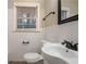 Bright bathroom features a white vanity, toilet, and white tiled walls at 2534 Ben Hill Rd, Atlanta, GA 30344