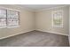 Inviting bedroom featuring neutral walls, gray carpeting, and natural light from the windows at 2534 Ben Hill Rd, Atlanta, GA 30344