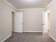 A bedroom with neutral walls, gray carpeting and two white doors at 2534 Ben Hill Rd, Atlanta, GA 30344