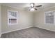 Bedroom featuring neutral walls, gray carpeting, and two bright windows at 2534 Ben Hill Rd, Atlanta, GA 30344