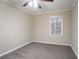 Bright bedroom featuring neutral walls, gray carpeting, and natural light from the window at 2534 Ben Hill Rd, Atlanta, GA 30344