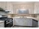 Functional kitchen showcasing white cabinetry, a modern stove, and sleek countertops at 2534 Ben Hill Rd, Atlanta, GA 30344