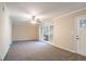 Bright living room with neutral walls, gray carpet, and sliding doors to the backyard at 2534 Ben Hill Rd, Atlanta, GA 30344