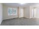 Bright living room boasts gray carpet, a front entry door, and a serene, minimalist interior at 2534 Ben Hill Rd, Atlanta, GA 30344