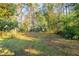 A view of the home's private, expansive, and partially fenced backyard at 3080 Santa Monica Dr, Decatur, GA 30032