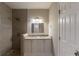 Bathroom featuring double sinks, a granite countertop, pebble shower floor, and tile shower walls at 3080 Santa Monica Dr, Decatur, GA 30032