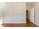 Bedroom features hardwood floors, a white baseboard, and an open doorway to another room at 3080 Santa Monica Dr, Decatur, GA 30032