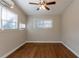 Bedroom with hardwood floors, neutral walls, ceiling fan, and bright windows at 3080 Santa Monica Dr, Decatur, GA 30032