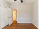 Spacious bedroom features hardwood floors, closet, ceiling fan, and hallway access at 3080 Santa Monica Dr, Decatur, GA 30032