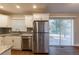 Kitchen featuring stainless steel appliances, granite counters, access to the backyard, and a light-filled space at 3080 Santa Monica Dr, Decatur, GA 30032