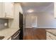 Kitchen with granite countertops, stainless steel appliances, and hardwood floors, flowing into living space at 3080 Santa Monica Dr, Decatur, GA 30032
