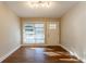 Bright room with hardwood floors, large windows, and a white door at 3080 Santa Monica Dr, Decatur, GA 30032