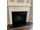 White fireplace mantel with a black hearth in the living room at 211 Buckland Dr, Alpharetta, GA 30022