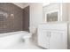 Modern bathroom with white vanity, dark tile, and shower/tub at 620 Goldsmith Ct # 107, Johns Creek, GA 30022