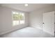 Bright bedroom featuring carpet flooring and a large window at 620 Goldsmith Ct # 107, Johns Creek, GA 30022