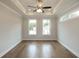 Spacious bedroom with hardwood floors, tray ceiling, and ceiling fan at 620 Goldsmith Ct # 107, Johns Creek, GA 30022
