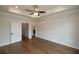 Spacious bedroom with hardwood floors and tray ceiling at 620 Goldsmith Ct # 107, Johns Creek, GA 30022