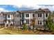 Brick townhome with black fence and landscaping at 620 Goldsmith Ct # 107, Johns Creek, GA 30022