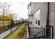 Brick townhome with black fence and landscaping at 620 Goldsmith Ct # 107, Johns Creek, GA 30022