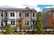 Brick townhome with black fence and landscaping at 620 Goldsmith Ct # 107, Johns Creek, GA 30022