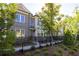 Brick townhome with black fence and landscaping at 620 Goldsmith Ct # 107, Johns Creek, GA 30022