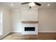 Modern fireplace with white stone and wood mantel at 620 Goldsmith Ct # 107, Johns Creek, GA 30022