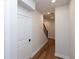 Basement hallway with hardwood floors and a staircase at 620 Goldsmith Ct # 107, Johns Creek, GA 30022