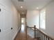 Bright hallway with hardwood floors and neutral walls at 620 Goldsmith Ct # 107, Johns Creek, GA 30022