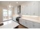 Modern kitchen with white cabinets, stainless steel appliances, and quartz countertops at 620 Goldsmith Ct # 107, Johns Creek, GA 30022