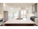 Kitchen boasts white cabinets, quartz countertops, and a large island at 620 Goldsmith Ct # 107, Johns Creek, GA 30022