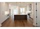 Modern kitchen with white cabinets, large island, and stainless steel appliances at 620 Goldsmith Ct # 107, Johns Creek, GA 30022