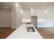 Kitchen island with quartz countertop, sink, and gold faucet at 620 Goldsmith Ct # 107, Johns Creek, GA 30022