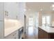 White kitchen cabinets and quartz countertops with hardwood floors at 620 Goldsmith Ct # 107, Johns Creek, GA 30022