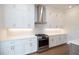 Stainless steel range and vent hood with white shaker cabinets at 620 Goldsmith Ct # 107, Johns Creek, GA 30022